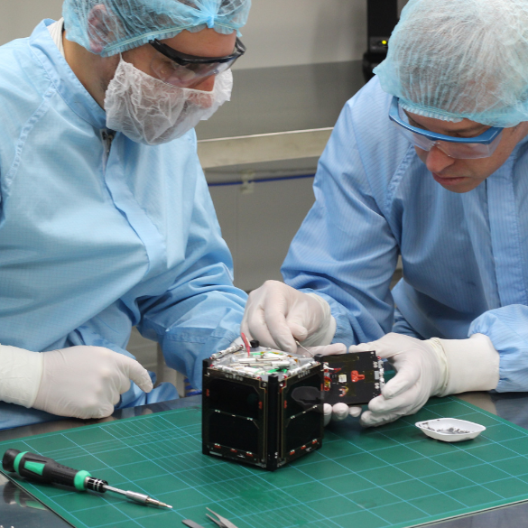 John Cater and Nick Rattenbury working on cube satellite